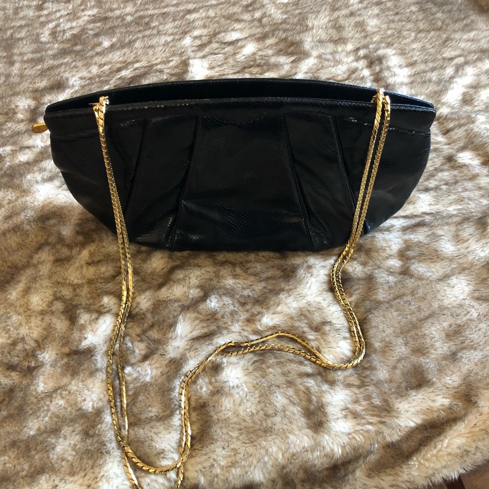 Judith Leiber (black snakeskin) clutch with gold tone chain.